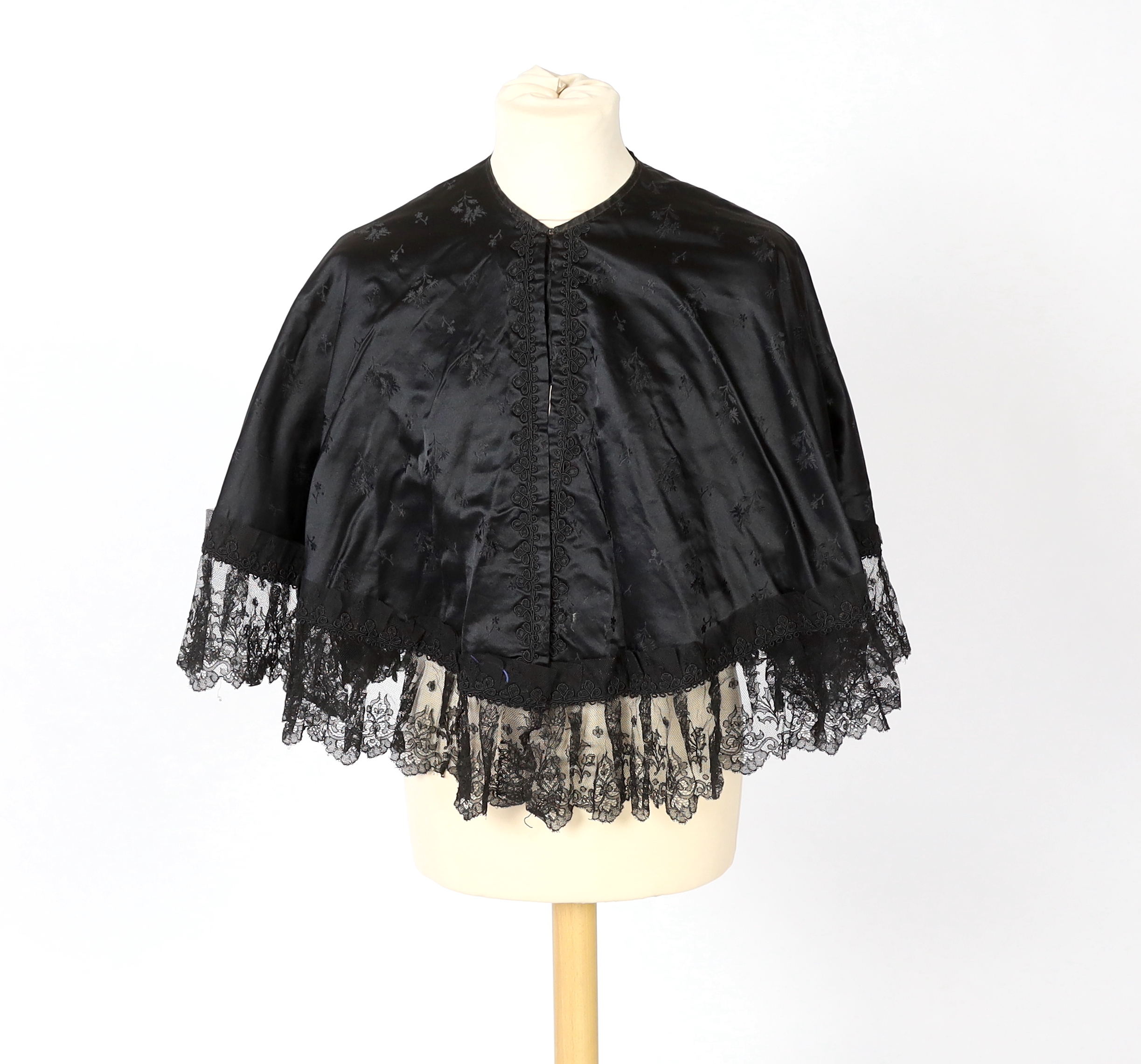 Two lady's Victorian black satin and lace, bead trimmed bodices, together with a black lace cape, a black satin cape, a small collection of coloured feathers and a child’s white worked pinafore